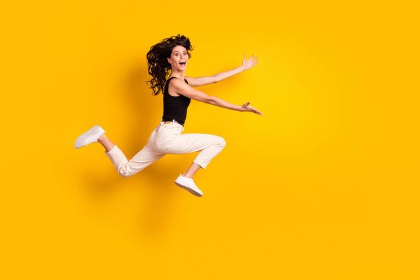 Full length body size side profile photo of woman running fast on meeting cheerful missed friends isolated bright yellow color background - Fotó, kép