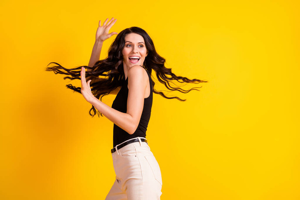 Profile side photo of young excited woman happy positive smile fly air hair isolated over yellow color background - Foto, Imagem