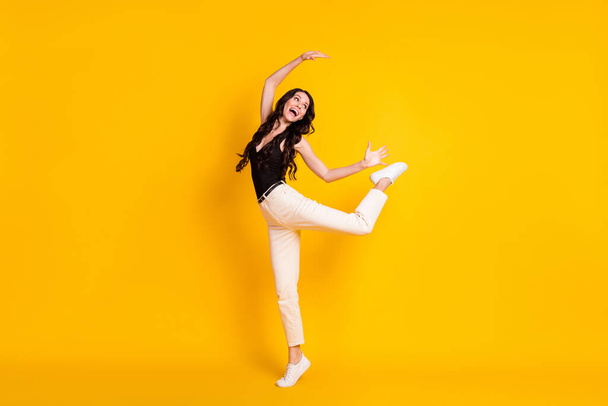 Full size profile side photo of young excited woman happy positive smile playful fooling isolated over yellow color background - Photo, image