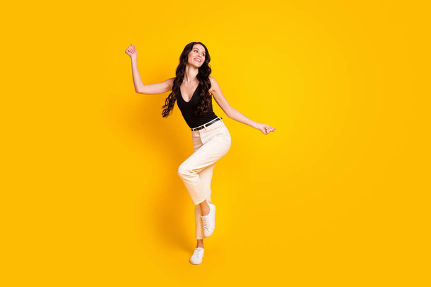 Full size photo of young cheerful girl happy positive smile have fun look empty space isolated over yellow color background - Fotografie, Obrázek