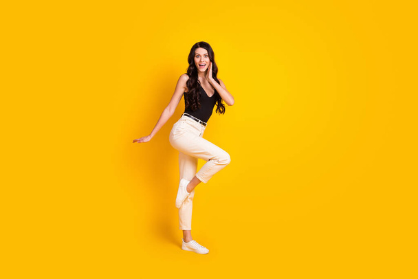 Full body profile side photo of young girl happy smile amazed shocked surprised sale news isolated over yellow color background - Fotoğraf, Görsel