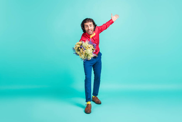Full size photo of young handsome funky funny gentleman give young bouquet isolated on teal color background - Φωτογραφία, εικόνα