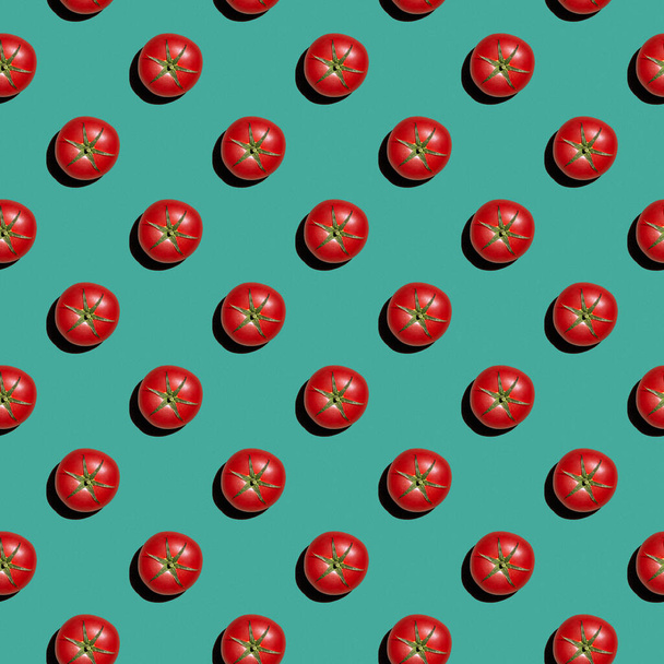 Pattern from fresh red tomatoes on a colored background. Healthy food concept. - Фото, изображение