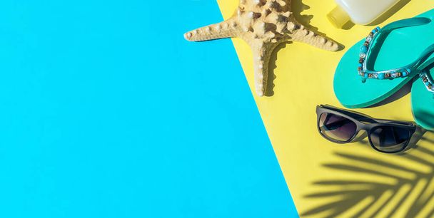 Dried starfish, sunscreen, sunglasses,blue beach flip-flop - Photo, image