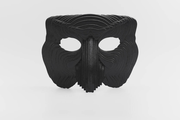 Μια μαύρη ξύλινη μάσκα σε λευκό φόντο. - Φωτογραφία, εικόνα
