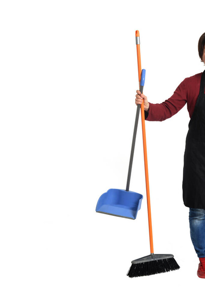 woman holding broom and dustpan on white background - Valokuva, kuva