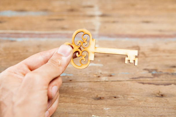 holding keys on a wooden background - Photo, Image