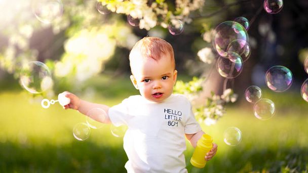 Portrait of a Little Boy Blowing Bubbles on the Streets - Fotó, kép