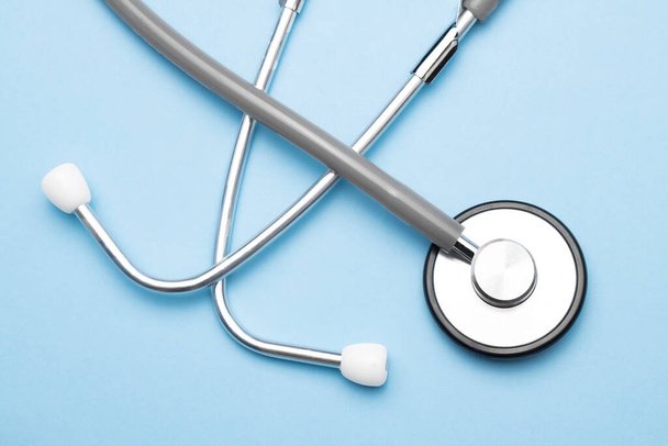 Grey stethoscope on blue background. Medical concept - Фото, изображение