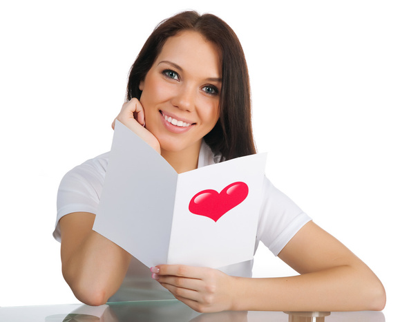 Cute young girl with a Valentine's card over white - Foto, Imagen