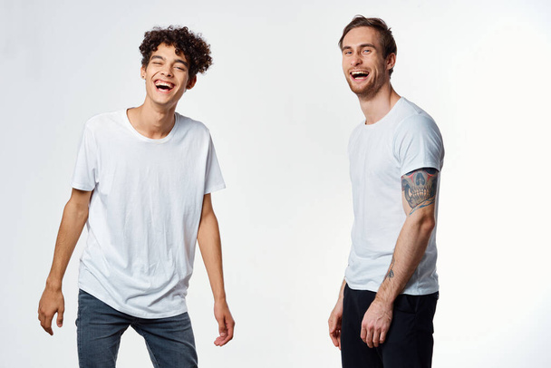 two man in white t-shirts emotions friendship fun - Фото, изображение