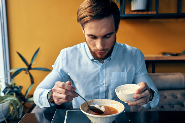 Man eating borscht and pilaf cafe restaurant interior business finance shirt model - Photo, Image