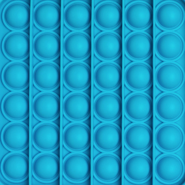 Abstrakter Hintergrund von Pop-it-Spielzeugblasen. Ein beliebtes Anti-Stress-Produkt. - Foto, Bild