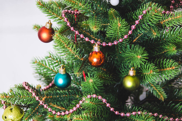 Christmas background - baubles and branch of artificial spruce tree - Fotografie, Obrázek