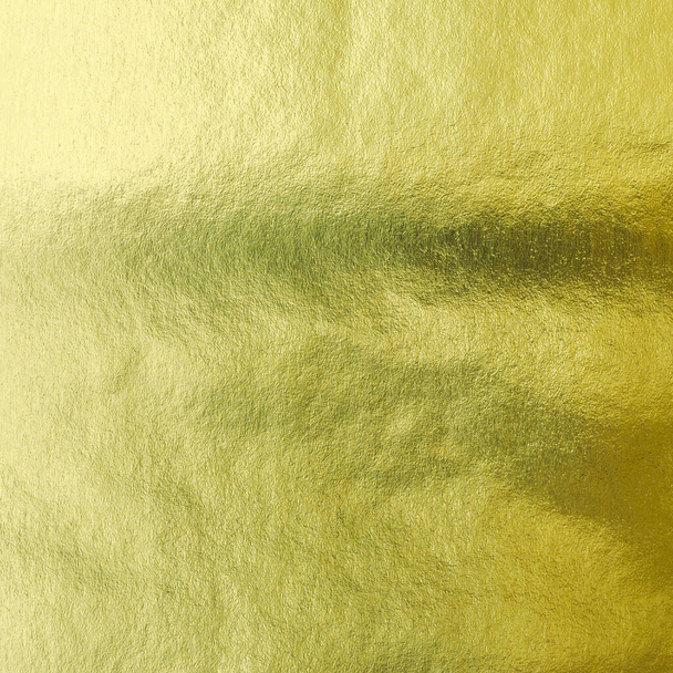 Gouden folie blad glanzend inpakpapier textuur achtergrond voor muur papier decoratie element - Foto, afbeelding