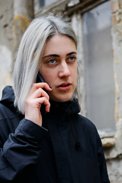 portrait of a girl with silver hair using smartphone on the street - Photo, Image