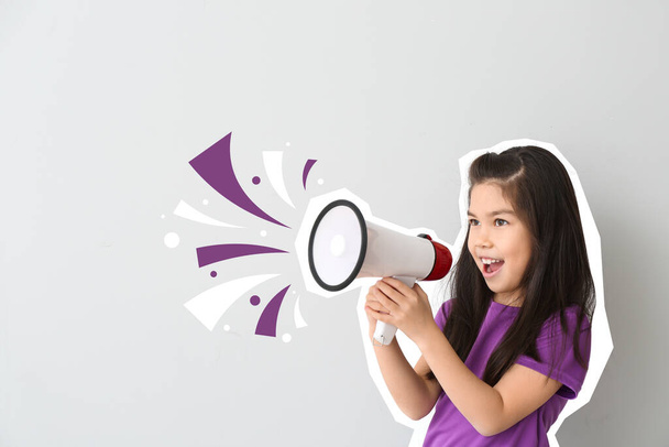 Cute little girl with megaphone on light background - Photo, Image