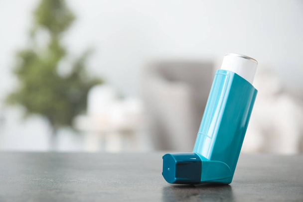 Modern inhaler on table at home, closeup - 写真・画像