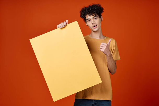 Kerl mit lockigem Haar Studio Werbung Attrappe roten Hintergrund - Foto, Bild