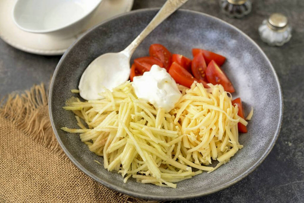 Add minced garlic, grated hard cheese and light sour cream. - Φωτογραφία, εικόνα
