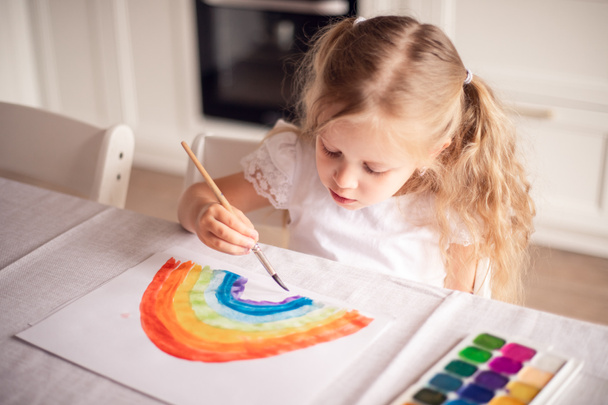 Lasst uns alles gut sein. Während der Covid-19-Quarantäne zeichnet das Kind zu Hause einen Regenbogen. Bleiben Sie zu Hause Social-Media-Kampagne zur Coronavirus-Prävention. Kinder erschaffen Künstler malt Kreativität Ferien. - Foto, Bild