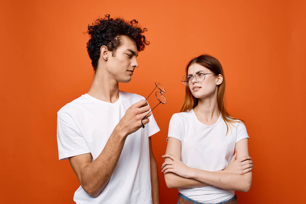 cheerful young couple in white t-shirts wearing glasses emotions - Foto, immagini