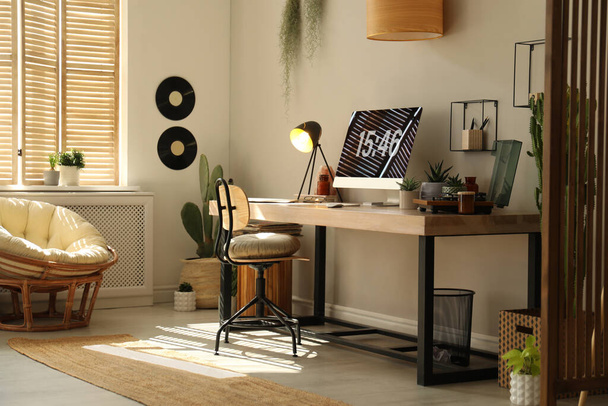 Room interior with comfortable workplace. Modern computer on wooden desk - Φωτογραφία, εικόνα