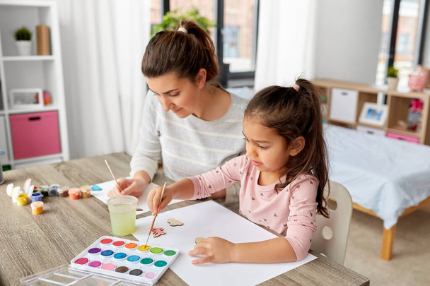 mother with little daughter drawing at home - Photo, image