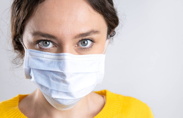 Young woman wearing hygienic mask to prevent infection coronavirus - Valokuva, kuva