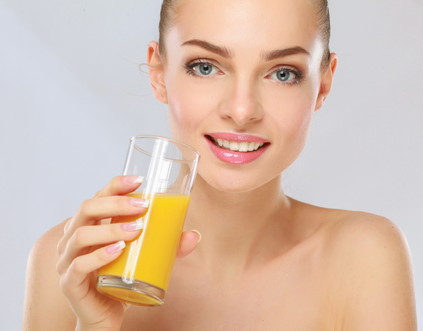 young woman with orange juice, isolated on white background - Zdjęcie, obraz