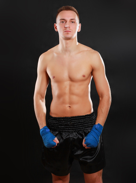Young handsome boxer man isolated on black background - Photo, image