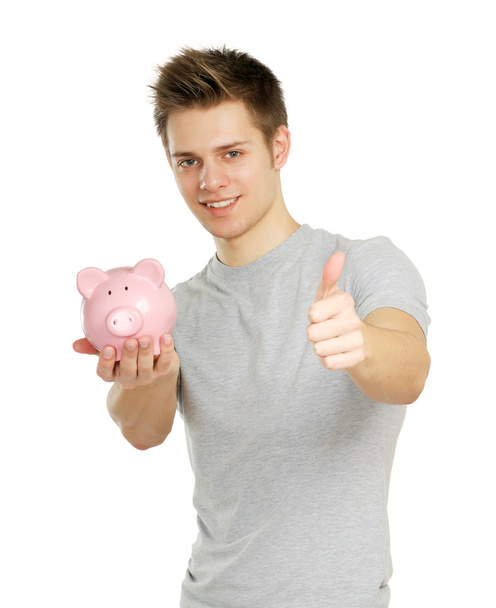 Young man holding piggy- box and showing ok, isolated o white backgriund - Fotografie, Obrázek