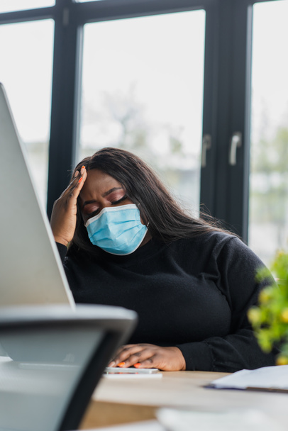 african american plus size businesswoman in medical mask suffering from headache  - Photo, Image