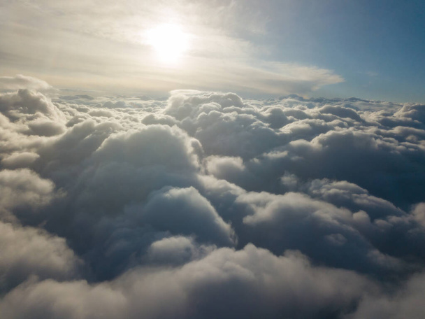 Aerial high flight above the clouds at sunrise. - Photo, Image
