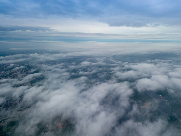 View of Kiev above the clouds at dawn. Aerial drone view. - Photo, Image