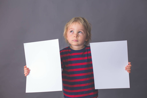Child, boy, showing different emotions, isoalted shot on gray background - Photo, image
