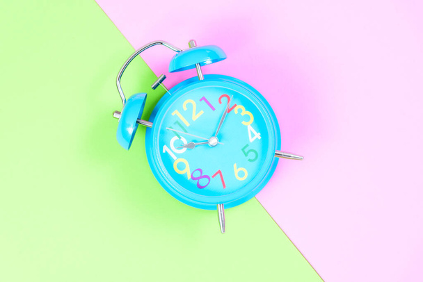 Синій будильник на рожевому і зеленому пастельному фоні або ізольований
 - Фото, зображення