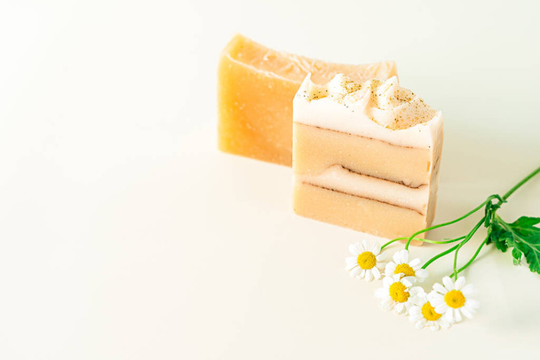 Homemade herbal Soap with chamomile Flowers on white marble background. Zero waste, natural organic bathroom cosmetics. Plastic free life. Ecological skin care, body treatment concept. - Фото, зображення