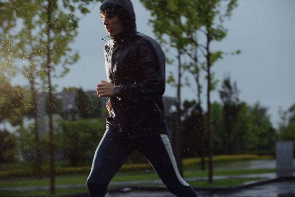 Man jogging under rain, flash light - Photo, Image