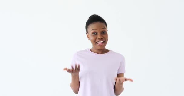 Woman greeting and explaining over white background - Кадри, відео