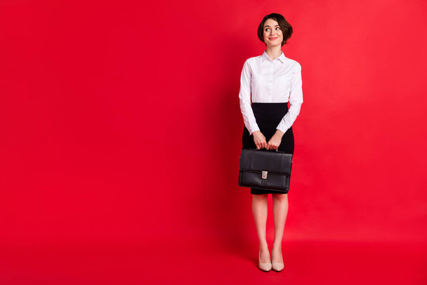 Full length body profile photo business woman keeping leather diplomat looking blank space isolated vivid red color background - Fotó, kép