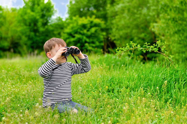 Young kid playing with binoculars - Photo, Image