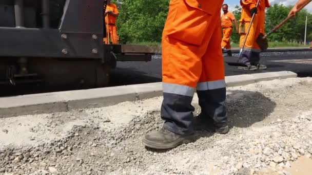 Makineye asfalt döşemek için düşük açılı görünüm hazırlanan zemine sıcak asfalt tabakası yaymak için. - Video, Çekim