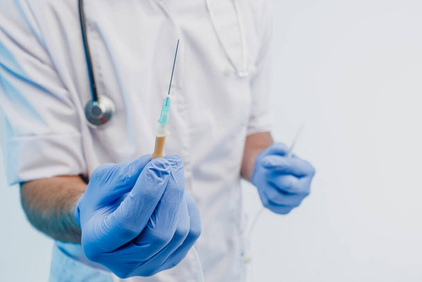 Close up of male doctor showing syringe in hand - Φωτογραφία, εικόνα