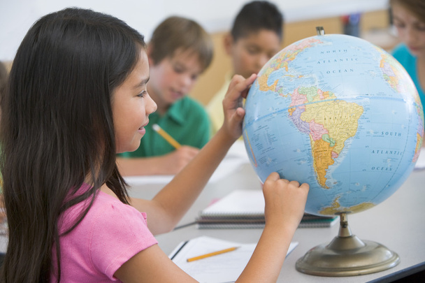 Elementary school geography class with globe - 写真・画像
