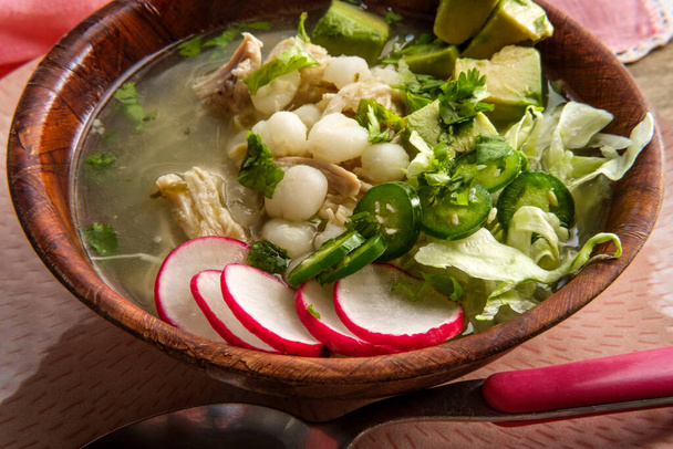 Mexican Pozole verde chicken and hominy stew with variety of fresh vegetable toppings to garnish - Photo, Image