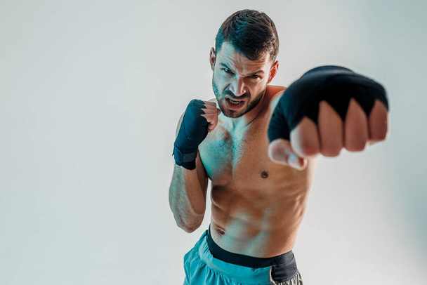 Angry young bearded european boxer is boxing - 写真・画像