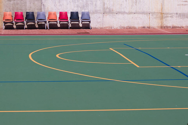 Detail of the university sports courts after classes when they are completely empty. You can see the chairs for the reserves of each sports team. - Zdjęcie, obraz
