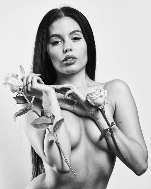 valentines day. sexy nude beautiful woman in flowers. love and romance. Spa treatments for skin rejuvenation. sexy naked woman hold rose flower. soft and tender. healthy woman hold rose with petals - 写真・画像