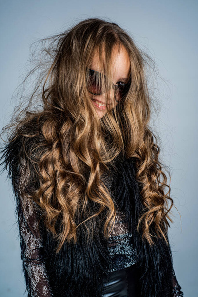 kid in glasses with stylish long curly hair hairstyle, hairdresser - Fotó, kép
